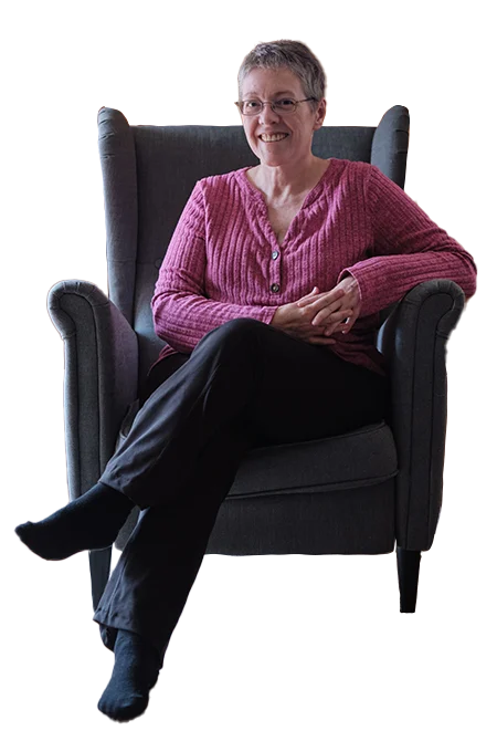Karen Dimmick, Tarot Reader, sitting in a chair